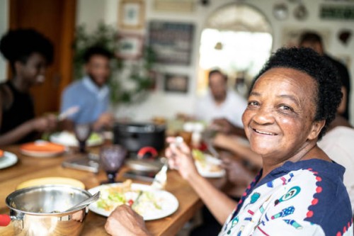 portrait of senior woman eating and looking at camera - food stock pictures, royalty-free photos & images