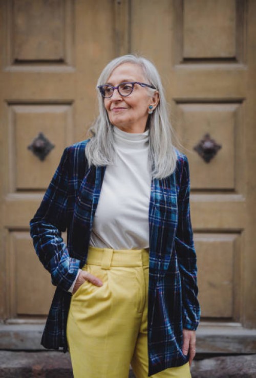 portrait of senior woman standing outdoors in town. - fashion stock-fotos und bilder