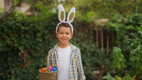 portrait of small cute boy on easter egg hunt game in back yard garden - garden decoration stock pictures, royalty-free photos & images