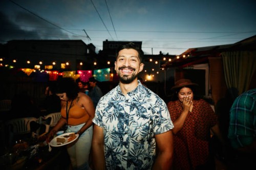 portrait of smiling man at backyard party with friends on summer evening - garden decoration stock pictures, royalty-free photos & images