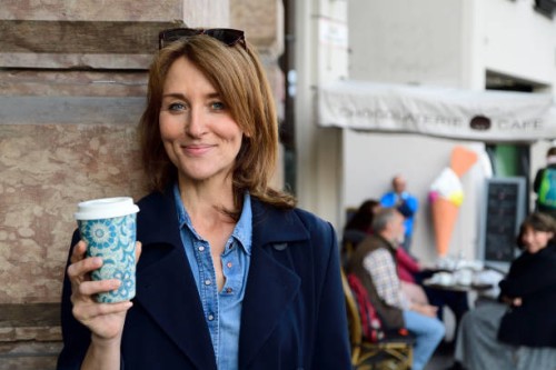 portrait of smiling mature woman with reusable bamboo cup in the city - junk food stock pictures, royalty-free photos & images