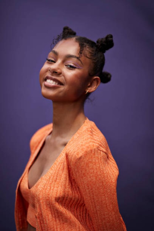portrait of smiling teenage girl in orange casuals - fashion stock pictures, royalty-free photos & images