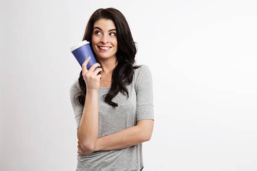 portrait of smiling young woman with coffee to go - junk food stock pictures, royalty-free photos & images
