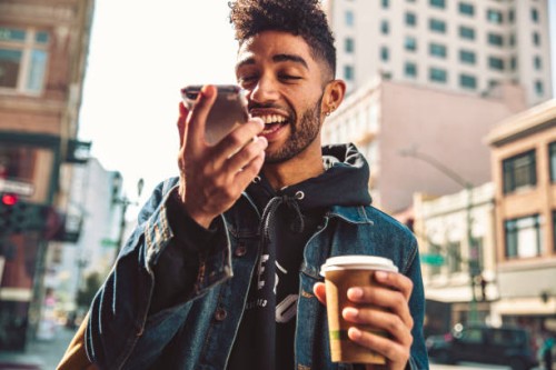 portrait of stylish young man with coffee and smartphone on the street - fashion stock pictures, royalty-free photos & images