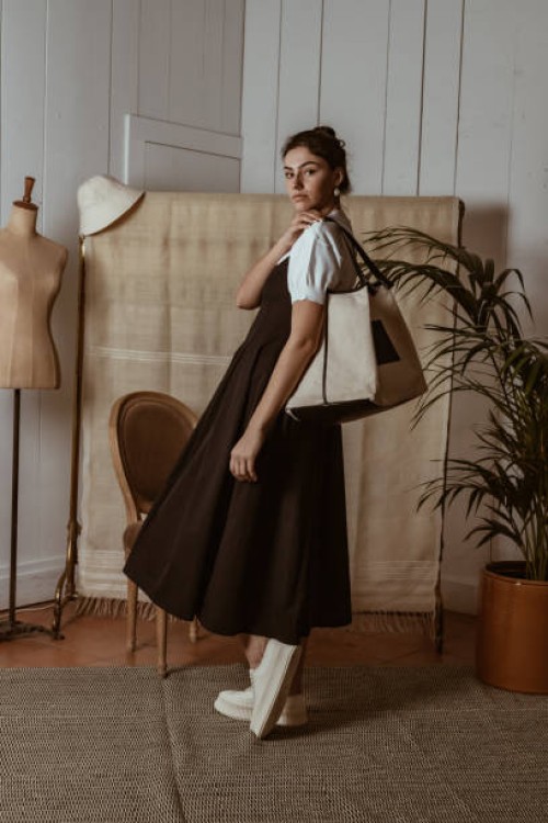 portrait of stylish young woman at home with reusable bag,houseplant and mannequin,avignon,france - fashion stock pictures, royalty-free photos & images