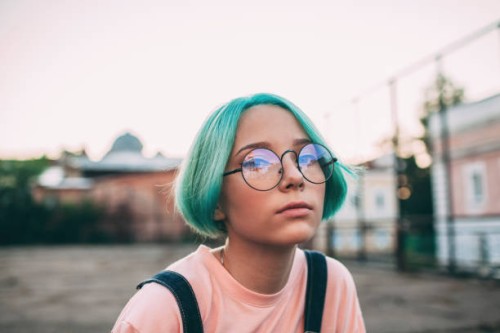 portrait of teenage girl with green dyed hair wearing eyeglasses - fashion stock pictures, royalty-free photos & images