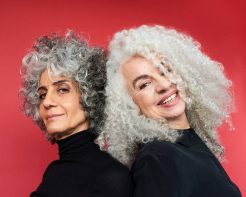 portrait of two women smiling - hairstyle stock-fotos und bilder