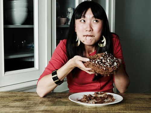 portrait of woman eating chocolate cake - food stock pictures, royalty-free photos & images