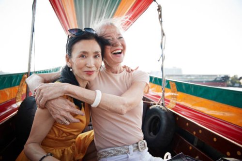 portrait of woman sitting with friend in boat - travel stock pictures, royalty-free photos & images