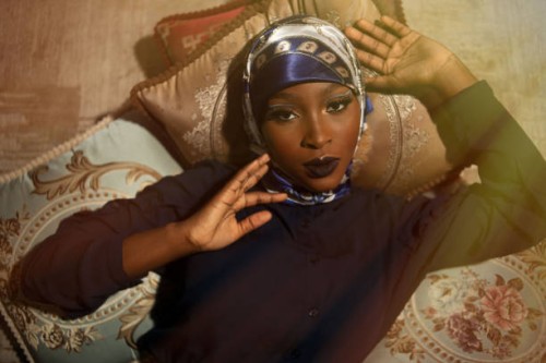 portrait of woman wearing traditional clothing while sitting on pillows and looking at camera,lagos,nigeria - fashion stock pictures, royalty-free photos & images