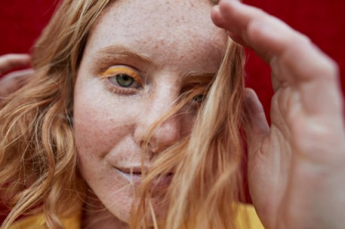 portrait of woman with freckles standing outdoors - fashion stock pictures, royalty-free photos & images