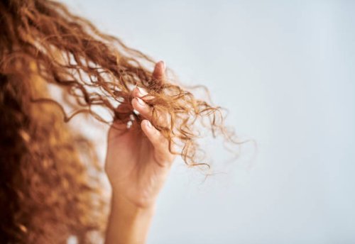 portrait of woman with natural, damaged hair and curly hair. girl with fingers in tips to show damage from hair treatment, split ends and dry hair. hair products, care and repair for healthy hair - hairstyle stock pictures, r