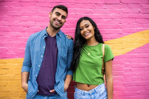 portrait of young generation z couple standing against brightly colored wall - fashion photos et images de collection