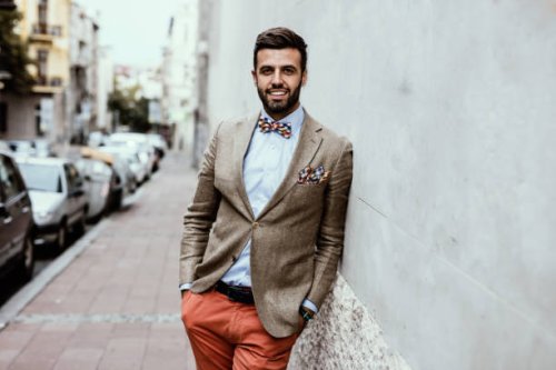 portrait of young handsome fashion blogger leaned on the wall. - hairstyle stock pictures, royalty-free photos & images