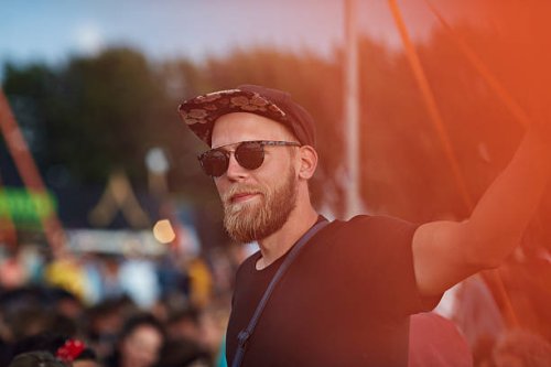 portrait of young man at music festival - concert stock pictures, royalty-free photos & images