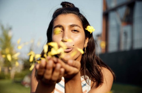 portrait of young woman blowing kiss of flowers - fashion stock pictures, royalty-free photos & images
