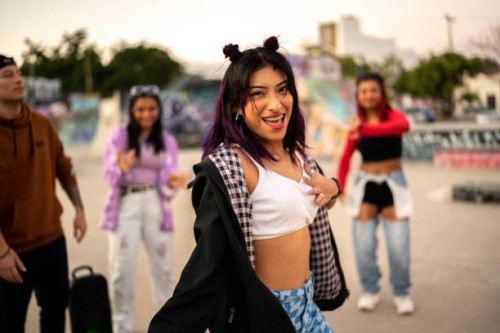 portrait of young woman dancing hip hop during street party with her friends - fashion stock pictures, royalty-free photos & images