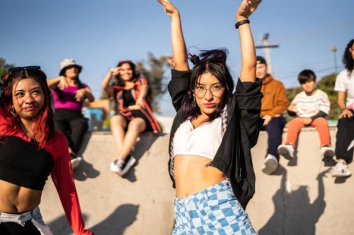 portrait of young woman dancing with her friends at street party - fashion stock pictures, royalty-free photos & images