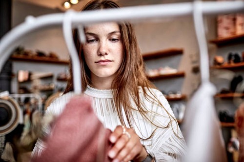 portrait of young woman in a fashion store - fashion stock pictures, royalty-free photos & images