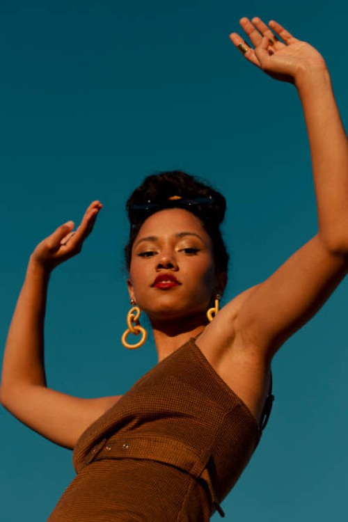portrait of young woman with hands up in the air against clear sky,kelowna,british columbia,canada - fashion stock pictures, royalty-free photos & images