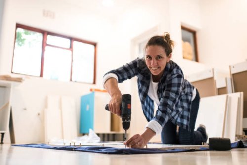 portrait woman using cordless power tool - home decoration stock pictures, royalty-free photos & images