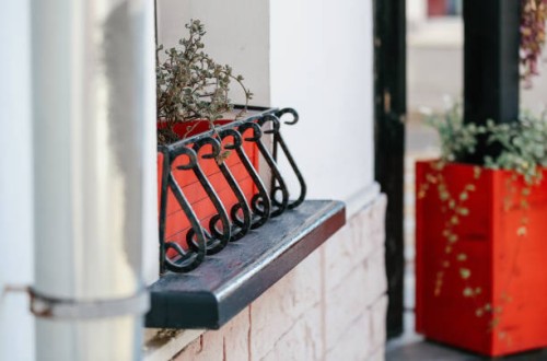 potted plants as the outdoors window decoration - garden decoration stock pictures, royalty-free photos & images