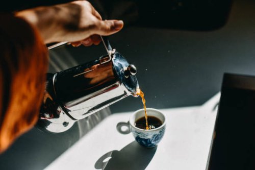 pouring espresso coffee into an espresso cup with a mocha pot. - coffee stock pictures, royalty-free photos & images