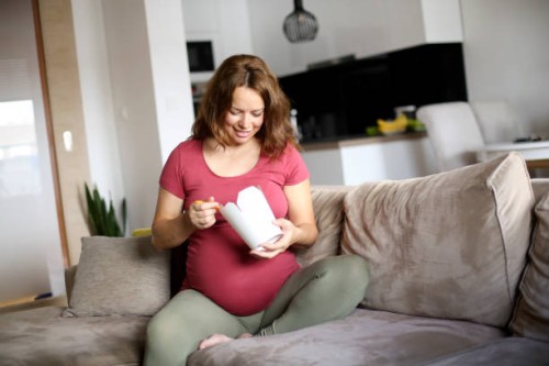pregnant woman eating chinese take away - junk food stock pictures, royalty-free photos & images