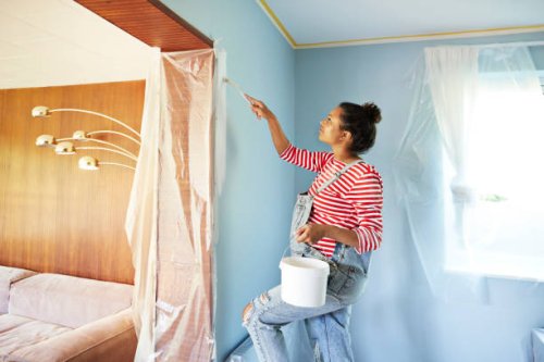 pregnant woman in bib overalls renovating room - home decoration stock pictures, royalty-free photos & images