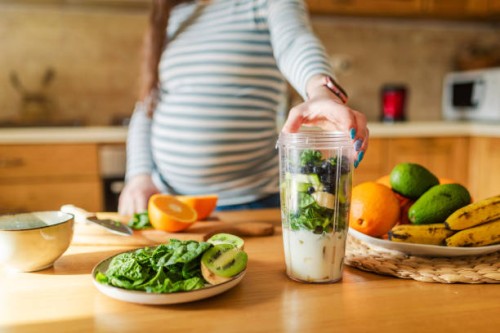 pregnant woman making healthy smoothie - food stock pictures, royalty-free photos & images