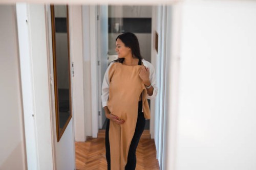 pregnant woman trying on maternity clothes - fashion stock pictures, royalty-free photos & images