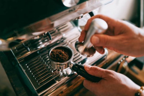 preparing an espresso at home - coffee stockfoto's en -beelden