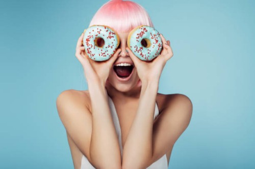 pretty blonde with multi-colored donuts - food stock pictures, royalty-free photos & images