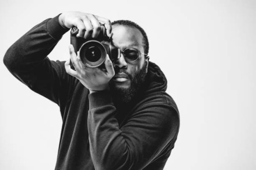 professional photographer at the studio, african american man wear black hoodie and sunglasses with digital camera is working. black and white concept photography - fashion stock pictures, royalty-free photos & images