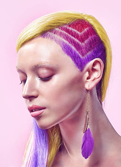 profile of lady with rainbow undercut and dyed hai - hairstyle stockfoto's en -beelden