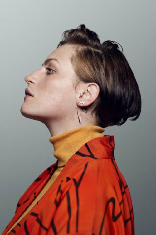 profile portrait of beautiful young woman looking in camera, shot on studio - fashion stock pictures, royalty-free photos & images