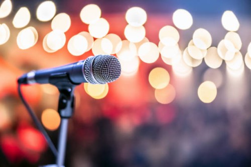 public performance on stage microphone on stage against a background of auditorium. - concert stock pictures, royalty-free photos & images