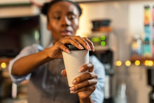 putting the lid on a coffee takeaway - junk food stock pictures, royalty-free photos & images