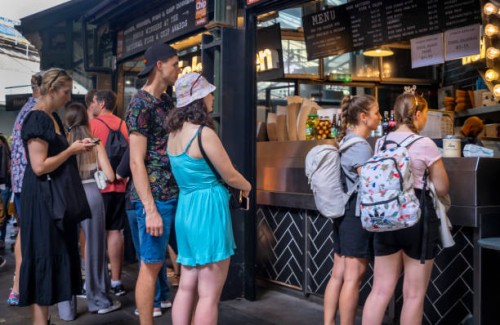 queuing for fish and chips at a stall in borough market - junk food stock pictures, royalty-free photos & images