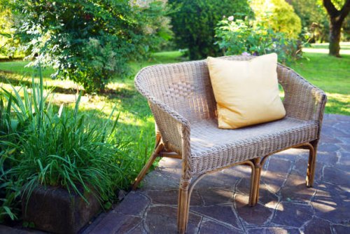 rattan bench with cushion in garden - garden decoration stock pictures, royalty-free photos & images