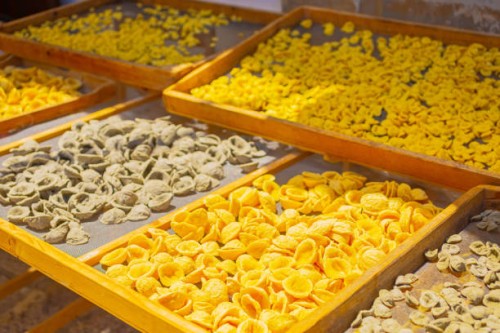 raw homemade conchiglie pasta on street in italy. traditional food. bari. - food stock pictures, royalty-free photos & images