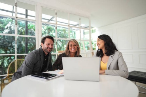 real estate agent talking to a couple in a house - home decoration stock pictures, royalty-free photos & images
