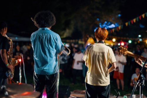rear view of a music group playing a live concert at an outdoor music festival - concert stock pictures, royalty-free photos & images
