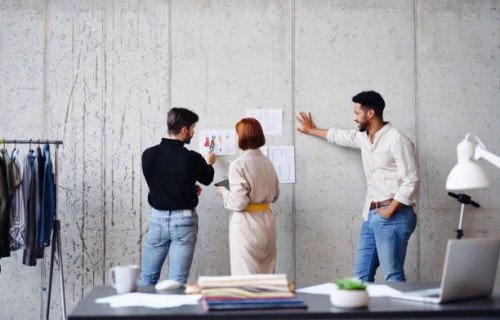 rear view of group of entrepreneurs designers, brainstorming. - fashion stock pictures, royalty-free photos & images