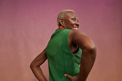 rear view of senior woman with hands on hips - fashion stock pictures, royalty-free photos & images