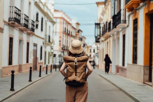 rear view of young asian female backpacker exploring the street - travel stock pictures, royalty-free photos & images
