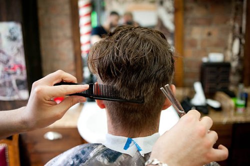 rear view of young man in barbershop having haircut - hairstyle stock pictures, royalty-free photos & images