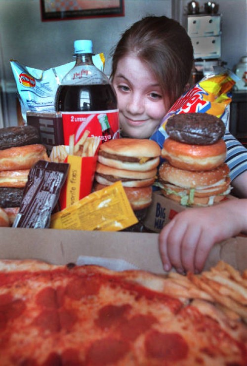 Rebecca Payne of Brookline in awash in junk food at her home. Staff Photo Michael fein saved in advance news and photo2