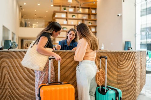 receptionist talking customers at hotel lobby - travel stock pictures, royalty-free photos & images