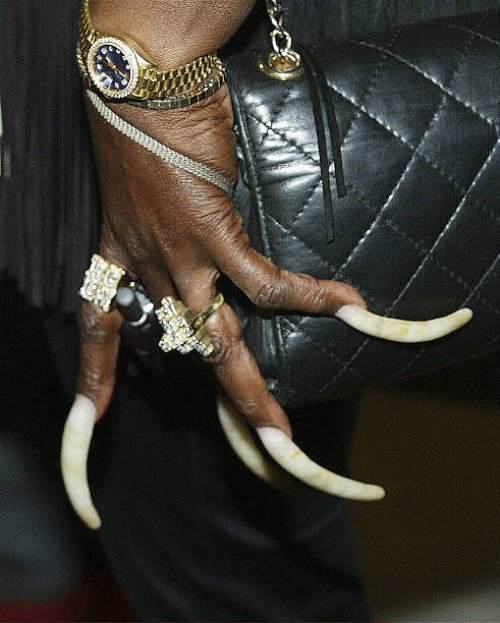 Recording artist Claudia White displays her fingernails during the opening of Donna Summer's Art Rock exhibit at the Entertainment Gallery in the...